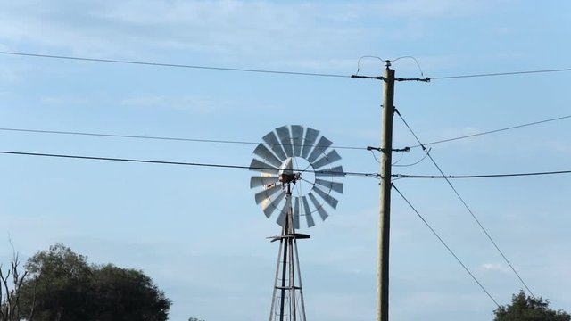 Medium shot of rotating windmill in Iowa, USA.