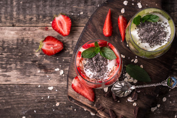 Healthy breakfast or morning snack with chia seeds granola, strawberries and kiwi, vegetarian food, diet and health concept