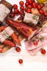Antipasto catering platter with salami and meat on a wooden background