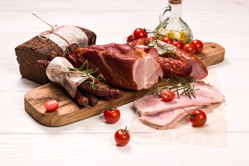 Antipasto catering platter with salami and meat on a wooden background