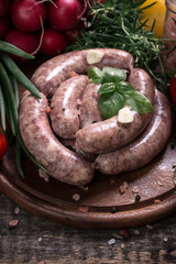 Fresh butcher cut meat assortment garnished with fresh rosemary on wooden table