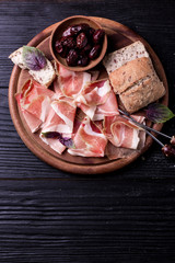 Curled Slices of Delicious Prosciutto with spice  Italian cuisine