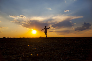 Fototapeta na wymiar Silhuette of girl on the sunset background