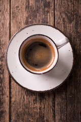 coffee cup and coffee beans on vintage wooden background