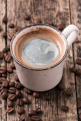 coffee cup and coffee beans on vintage wooden background