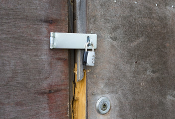 An old door with double locks on it.