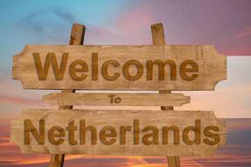 Welcome to Netherlands sign on wood background with blending national flag