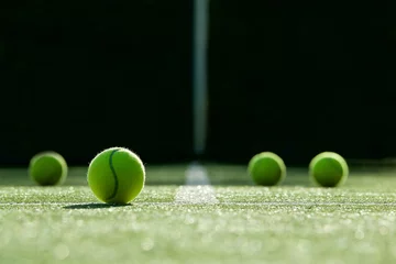 Wandaufkleber soft focus of tennis ball on tennis grass court © kireewongfoto