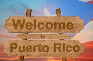 Welcome to Peurto Rico sign on wood background with blending national flag