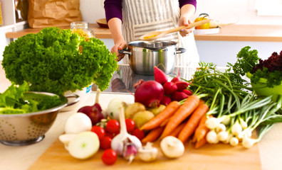 Young Woman Cooking in the kitchen. Healthy Food
