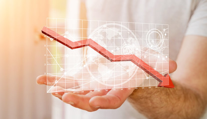 Businessman holding digital charts bars and red arrow