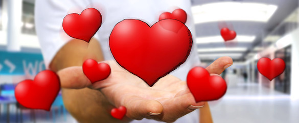 Young man holding hand drawn red heart