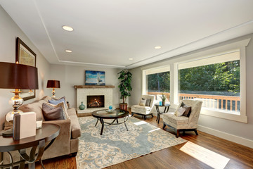 Cozy living room interior with hardwood floor and window view.