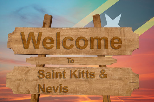 Welcome to Saint Kitts & Nevis sign on wood background with blending national flag
