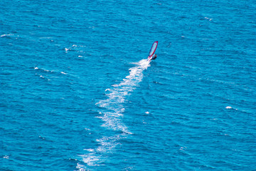 Windsurfer on blue sea