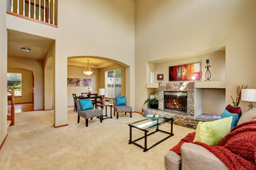 Cozy luxury family room with high ceiling and arched doorway