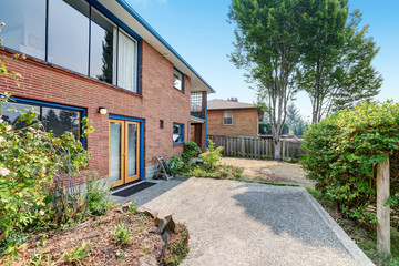 Red brick house exterior. Fenced Backyard with concrete floor.