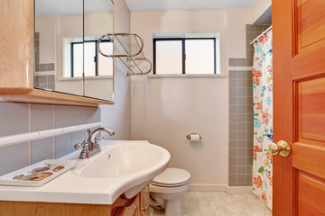 Light tones bathroom interior with grey tile wall trim