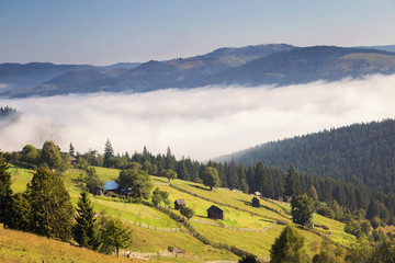 Obraz premium Beautiful foggy morning in the romanian village, in Bucovina