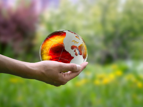 Large, luminous ball on a female hand. The concept of the death of the planet, global disaster, environmental destruction