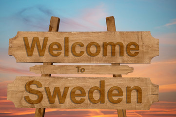 Welcome to Sweden sign on wood background