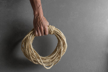 Hand holding ship rope