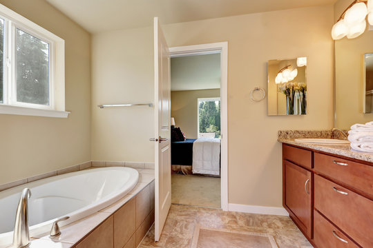 Photo of a mid-sized bathroom with wood cabinets