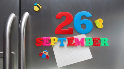 September 26 calendar date made with plastic magnetic letters holding a note of graph paper on door refrigerator