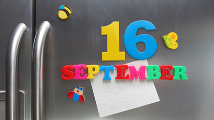 September 16 calendar date made with plastic magnetic letters holding a note of graph paper on door...