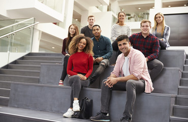 Portrait Of Student Group On Steps Of Campus Building
