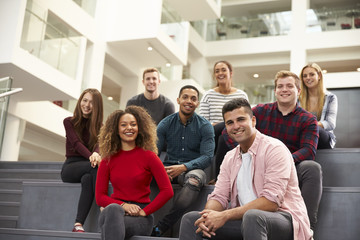 Portrait Of Student Group On Steps Of Campus Building