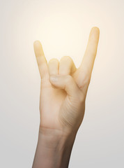 close up of woman hand showing rock sign