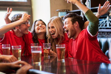 football fans or friends with beer at sport bar