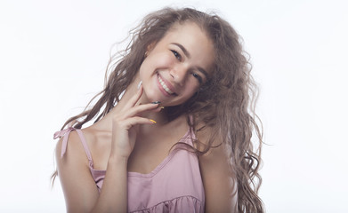 Fototapeta premium portrait of attractive teenager girl smiling in cheerful mood on white background.