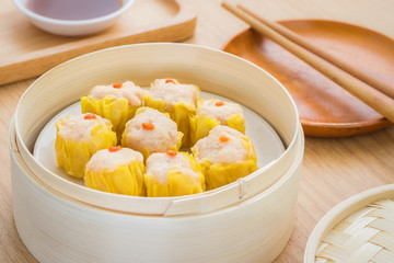 Steamed dumplings in bamboo steamer basket