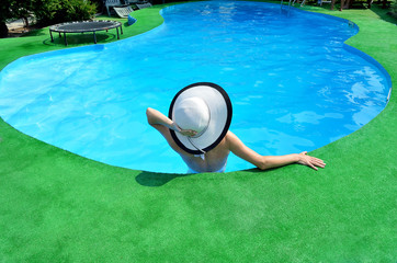 Fototapeta na wymiar Sexy young woman relaxing in the pool.