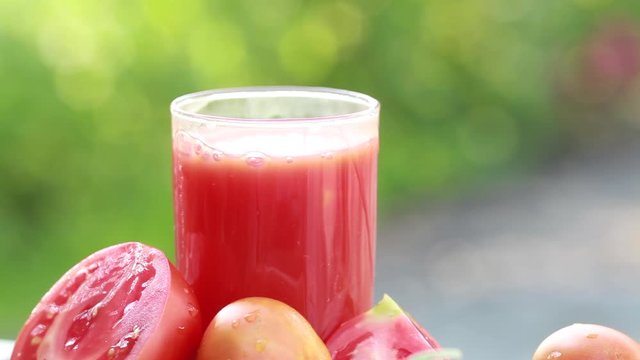 Spray ripe tomato juice in a glass