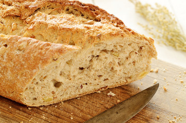 Close-up of fresh wheat bread  on wooden cutting board