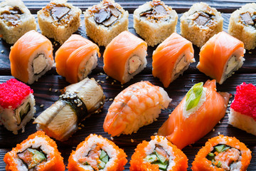 Set of sushi rolls and nigiri on a black background closeup
