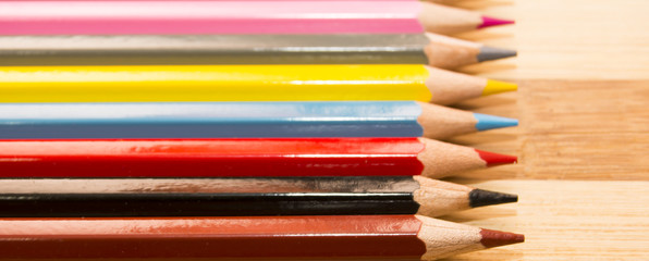 Fototapeta premium Colored pencils isolated on wooden background