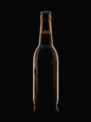 Beer glass bottle with cap isolated on black background