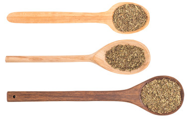 Provence herbs in a wooden spoon on a white background