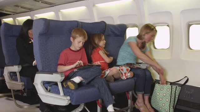 Mother with two small children on plane