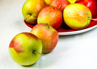 Autumn apples on a white wooden table
