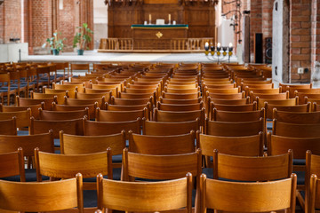 Rows of church chairs.Interior of chapel. Latvia, Riga.