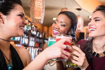 Girls enjoying nightlife in a club, drinking cocktails