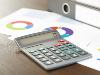 Calculator and Stack of Ring Binders