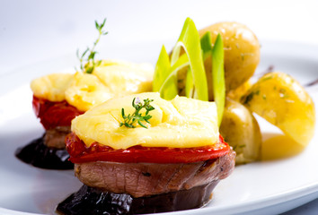 Canapes of eggplant, meat, cheese and tomatoes