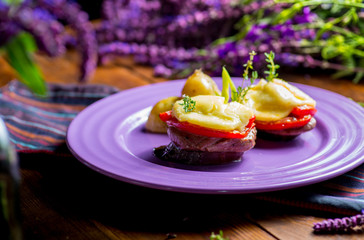 Canapes of eggplant, meat, cheese and tomatoes