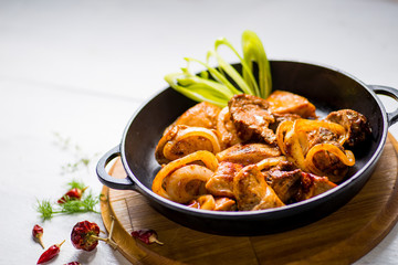pan fried meat served on a wooden table